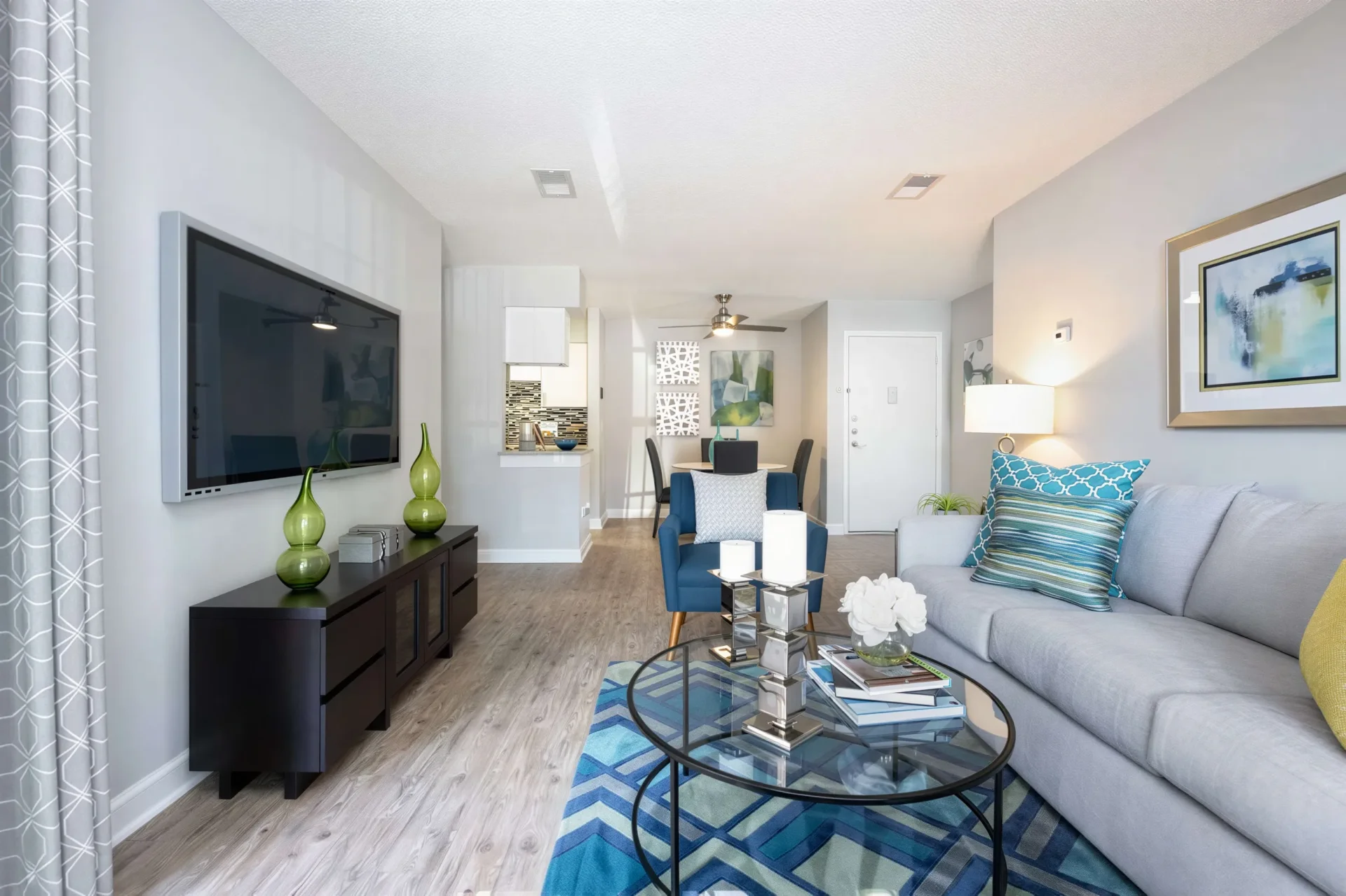 Open-concept apartment living and dining area with modern flooring at Arbour Ponds Apartments in Tampa